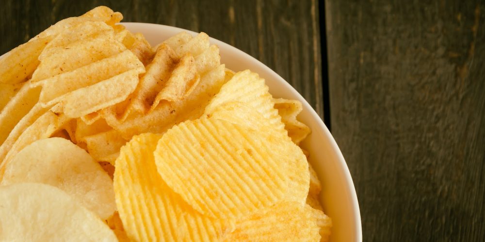 potato chips on wood - soft focus with vintage film filter